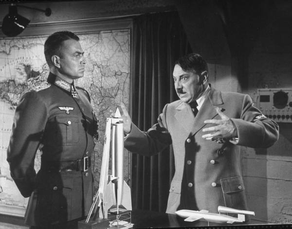 Rommel (James Mason) listens while Hitler (Luther Adler) explains how the new V weapons will win the war