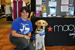 Picture of me kneeling down and posing with bob in front of our booth