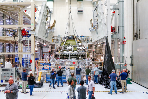 Inside the Neil Armstrong Operations and Checkout Building at NASA's Kennedy Space Center in Florida, the Orion capsule is mated to its European Service Module for the Artemis 2 mission...on October 19, 2023.