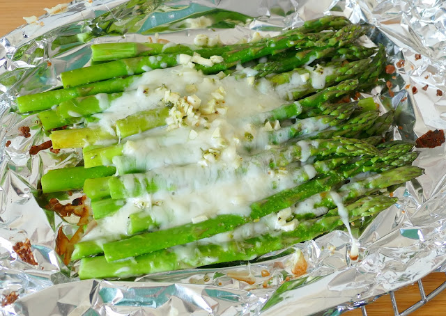 This side dish is simple to make on the grill or in the oven! It combines easy ingredients like asparagus, cheese, garlic, butter and seasonings for a mouthwatering side to go with chicken, beef, fish, seafood or pork! Great as a meatless meal too!