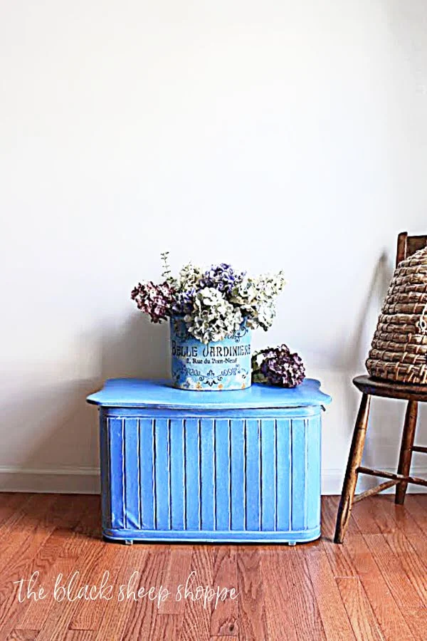 Painted vintage clothing hamper in bright blue.