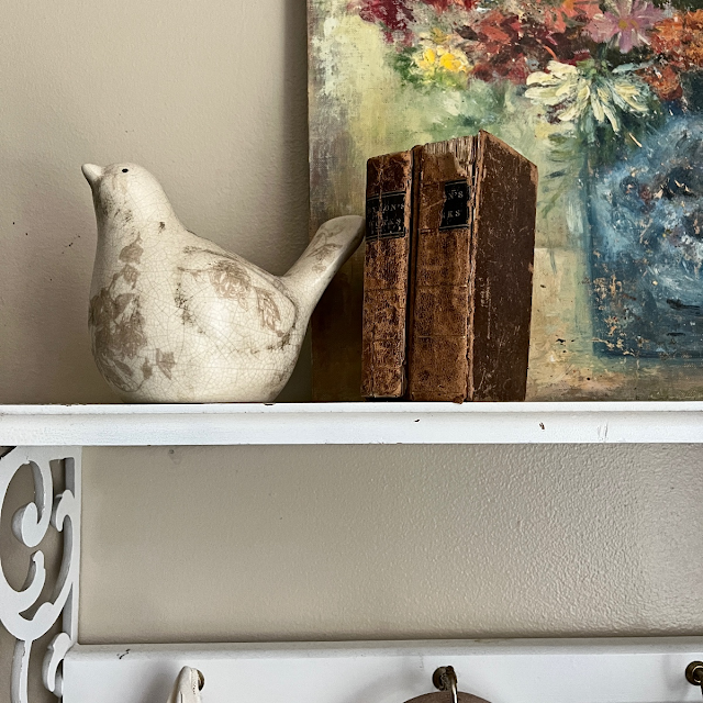 pottery bird and antique books