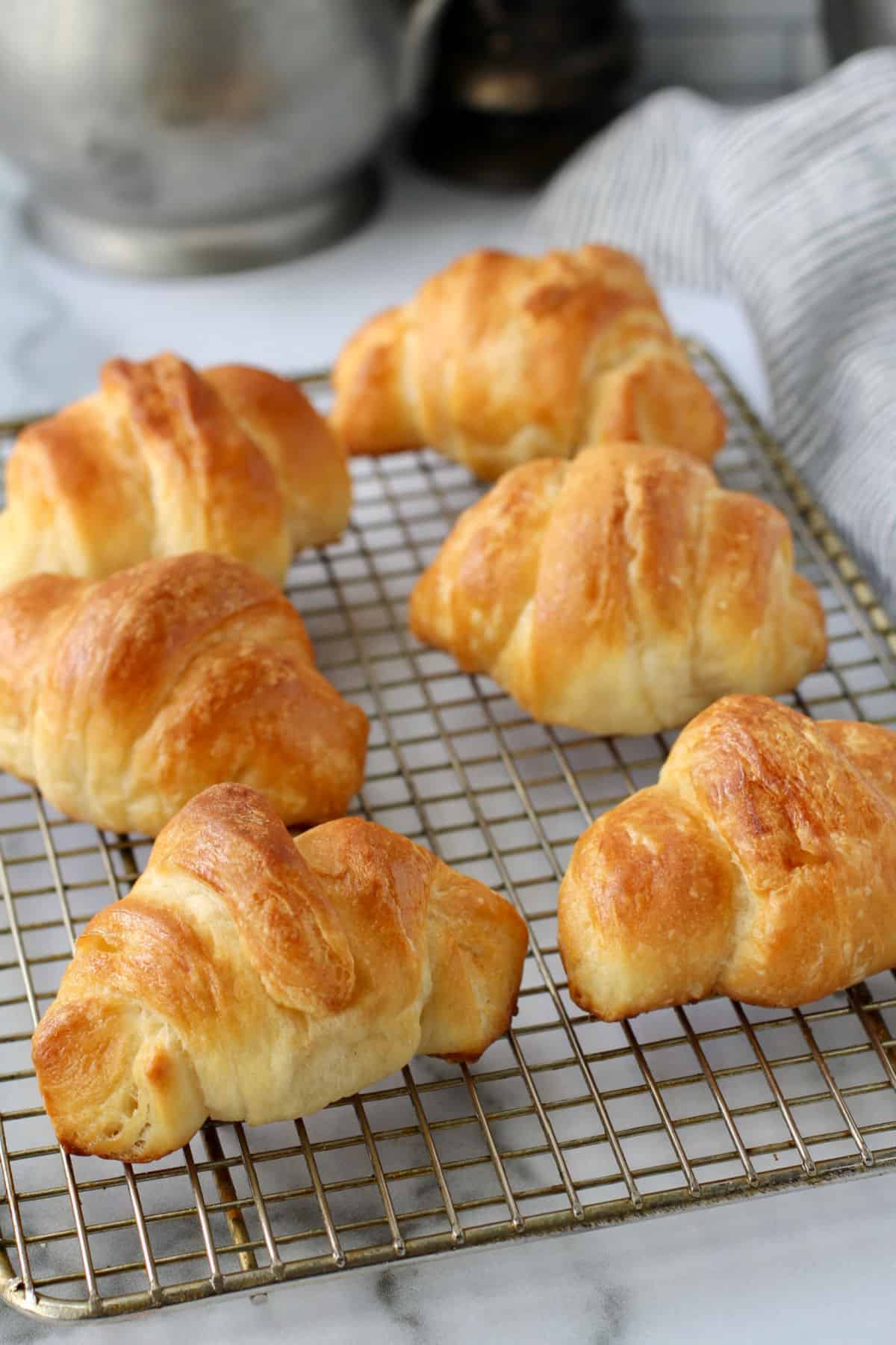 Flaky Buttery Crescent Rolls on a cooling rack.