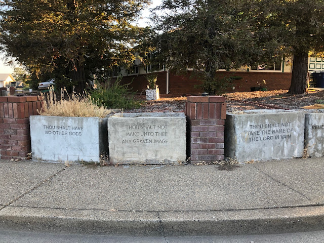 home fence made to look like stone tablets