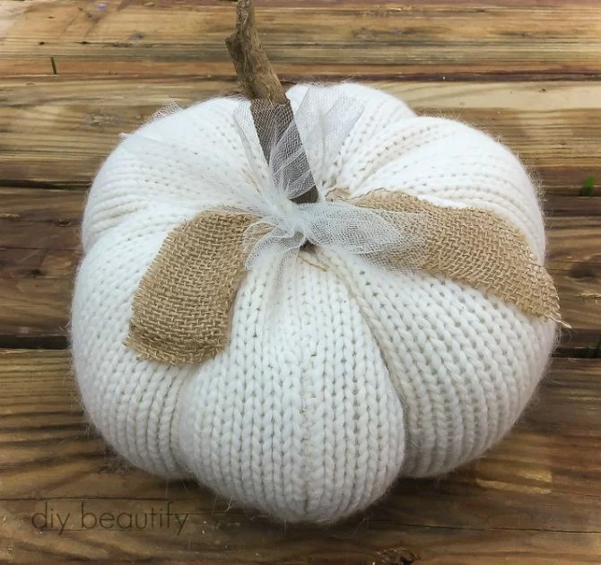 white sweater pumpkin with burlap and stick stem