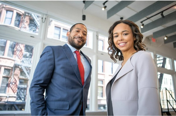 Two salesperson smiling showing positive emotions