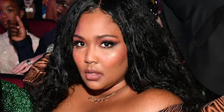 <img src="Lizzo's Empowering Message: Embracing Positivity and Resilience in the Face of Negativity”>