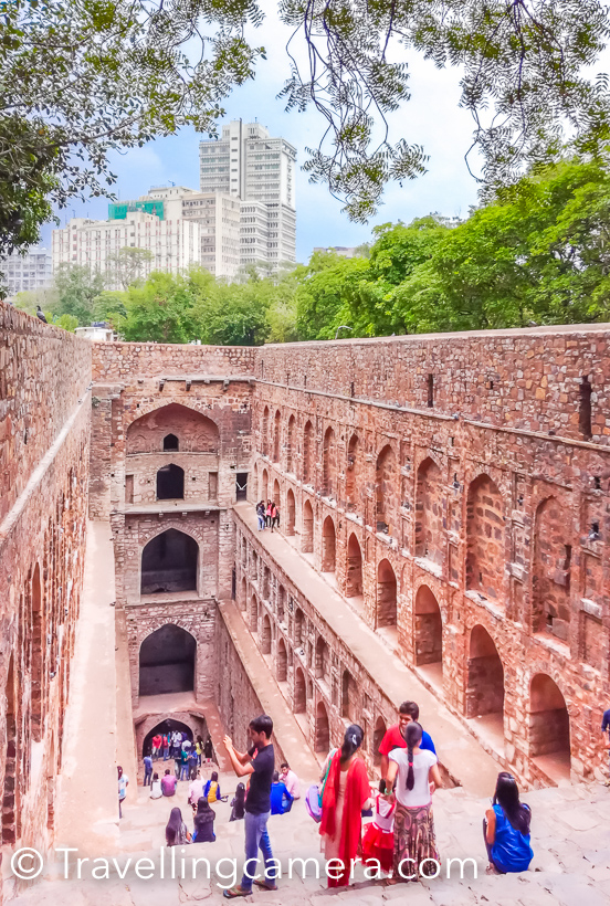 When loitering around in Cannaught Place or navigating traffic on Barakhamba Road, it is difficult imagine that barely 5-minutes away, hidden amongst trees, lies the magnificient stone structure of Agrasen ki baoli. The 14th-century step well was restored by the Archaeological Survey of India in the year 2002. Now the Baoli is clean and well-maintained. We visited Agrasen ki Baoli on a humid Sunday afternoon and were expecting to find a more or less abandoned structure with may be a couple of people loitering about here and there. But we were in for a surprise. The baoli was buzzing with well-dressed, pouting, selfie-clicking youngsters. They were there in such large numbers that it was difficult to capture even a single shot without people in it. This was heartening. I don't know whether this popularity is because the Baoli was recently featured in the popular Bollywood film PK or because the Baoli is clean, litter-free and situated barely a kilometre away from the heart of the city. It may be all of these, but it is wonderful to see the hard work of the ASI bearing fruit. Usually when we head out to explore the city, we make sure that we carry a DSLR and all the required lenses, but this time we had decided to do something different. The impact of camera phones on the photography ecosystem is the hot topic for debate nowadays, and we decided to settle it with a practical. So this time instead of a DSLR, we were carrying a smartphone - Honor 5c to be precise. All the pictures that you are seeing in this post have been clicked using Honor 5c. Based on the results, we can comfortably say that for everyday non-professional use, a smartphone, if used well, can suffice. One would of course need to study all the capabilities and features of the particular smartphone camera in details to be able to use them in appropriate situations. Coming back to the Baoli, we captured the structure, the pigeons peeping out of the gaps in the walls, the contrast between the modern skyscrapers of CP and the medieval architecture of the Baoli, the people exploring the structure and a lot more. The baoli is situated in one of the lanes branching out of the very pretty Hailey road, and this lane is dotted with some very interesting grafitti. We captured some of that too. If you haven't yet seen Agrasen ki Baoli, we recommend that you should. But make sure that the day is pleasant and you have time on your hands, because there is a lot to take in at the Baoli and in the surroundings.    