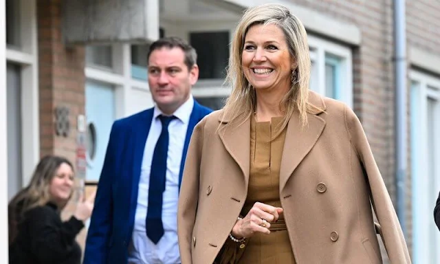 Queen Maxima wore a brown camel Madame wool coat by Max Mara, and Florinata midi dress by Zeus + Dione