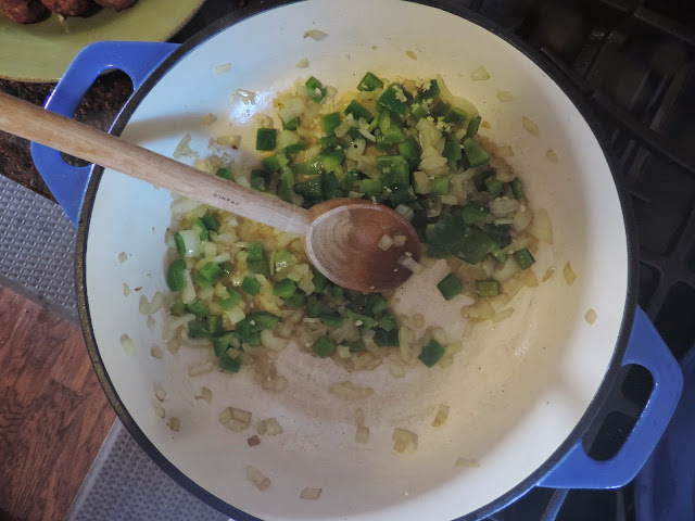 Green peppers and onions sautéing in the pan.