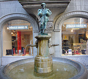 Bronze fountain, man with geese.