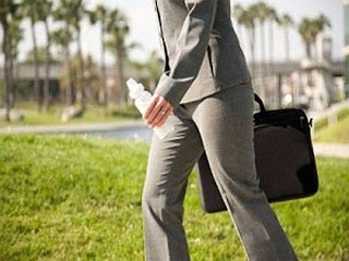 working mum image in a suit with a baby bottle 