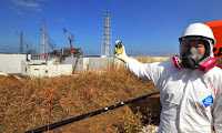 A journalist checks radiation levels at stricken Fukushima Dai-ichi nuclear power plant. The 2011 disaster, which will cost Japan over $100 billion, set back the nuclear industry worldwide. (Photo Credit: AP) Click to Enlarge.