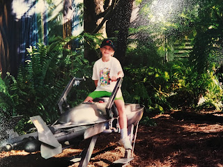 author sitting on a Disney World Star Wars land speeder