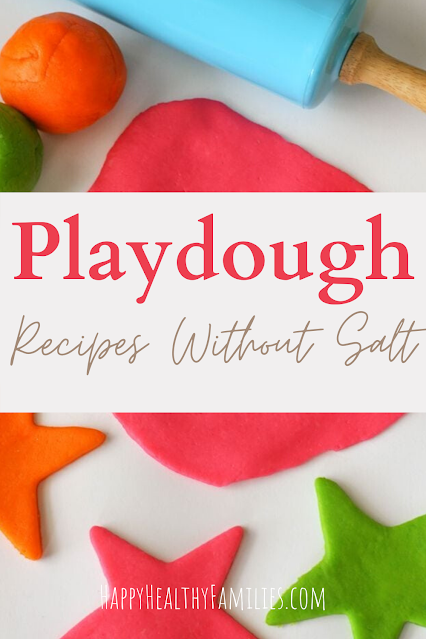 orange, green, and red playdough, a blue rolling pin and red and green stars made out of playdough