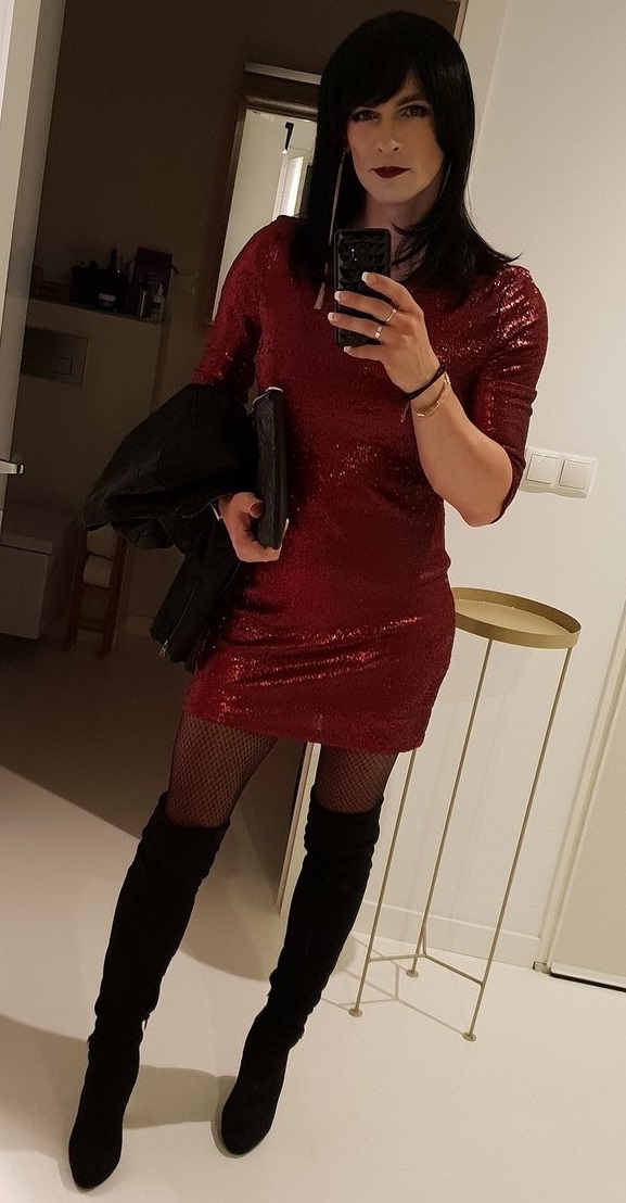 Pretty crossdresser ready to go out and have fun in a short dress, fishnet pantyhose and boots