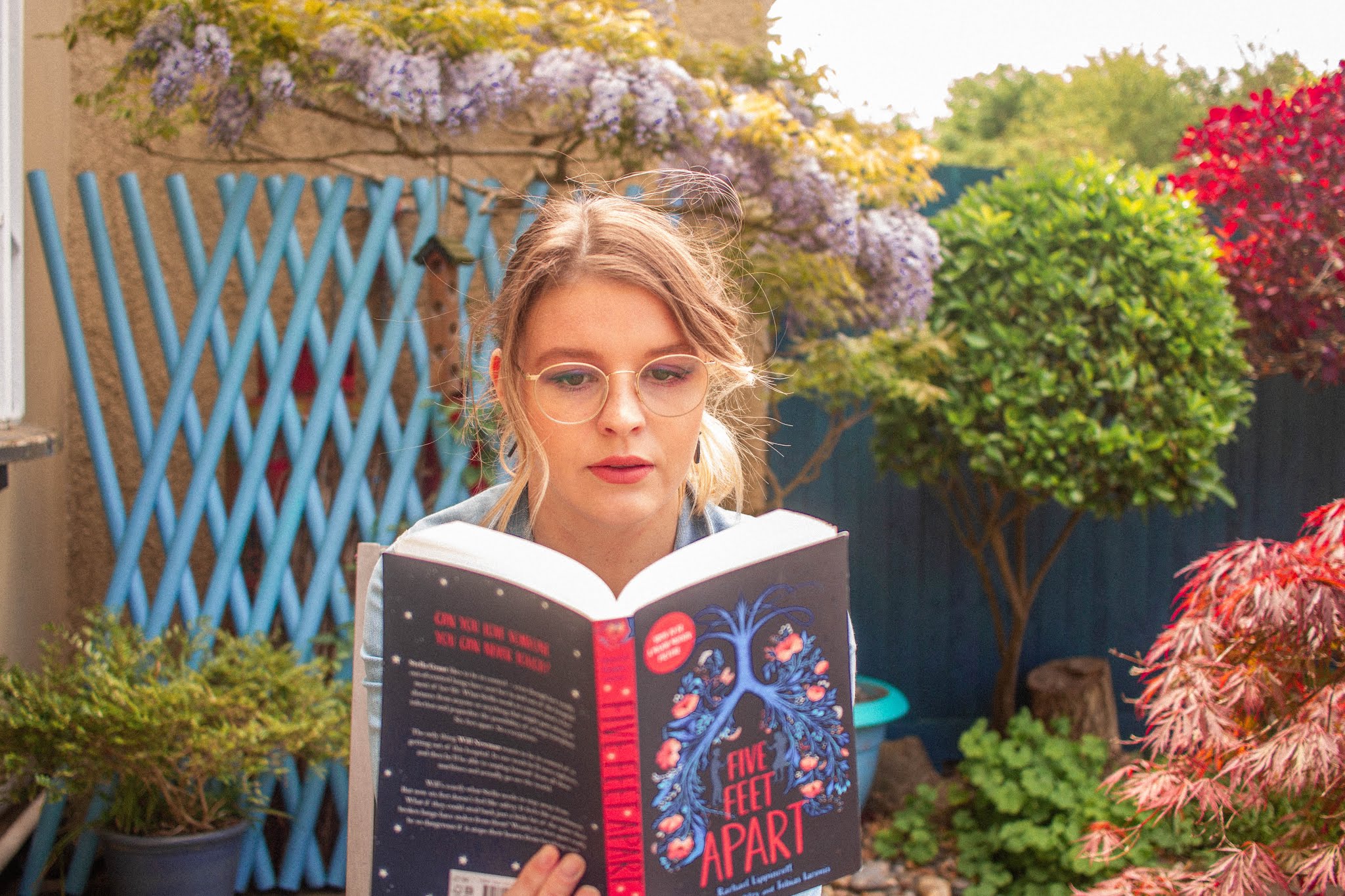 blonde girl reading five feet apart by Rachael Lippincott - book and film review blogpost