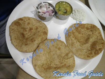 Image of Puri masala with potato gravy, raita and coconut chutney. 