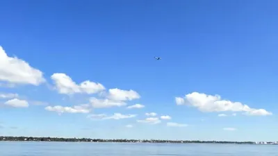 C-17 aircraft and silver UFO sighting by shark fisherman.