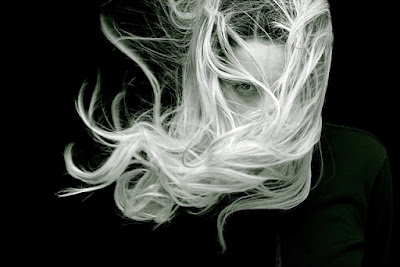 A dark image of a girl with her white hair blowing very fastly- sad girl dp