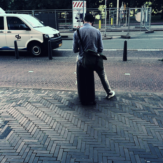 Man zittend op koffer