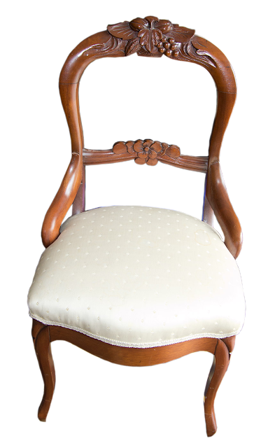 Another Victorian chair, this one open-backed and carved from walnut, covered in an off-white silk fabric.