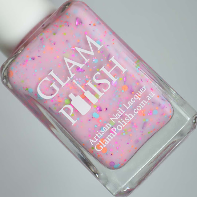 pink nail polish with glitter in a bottle