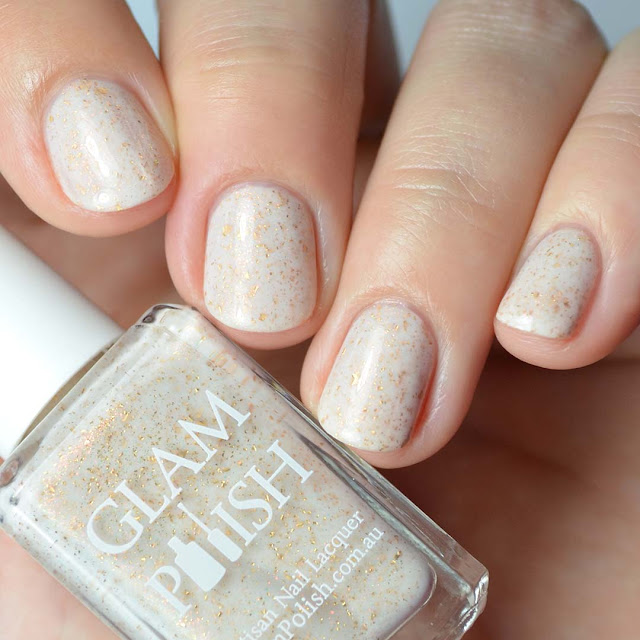 cream nail polish with gold flakies and shimmer