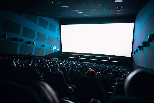 people watching movie in theatre