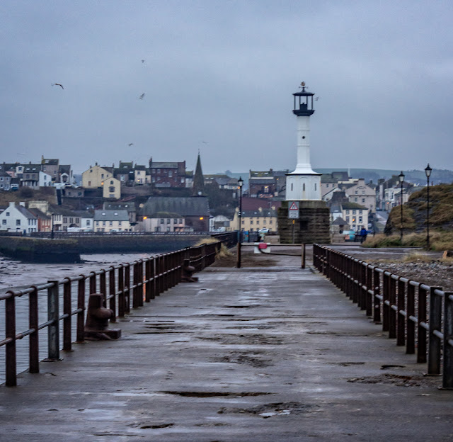 Photo of Maryport lighthouse with the town in the distance through the mist