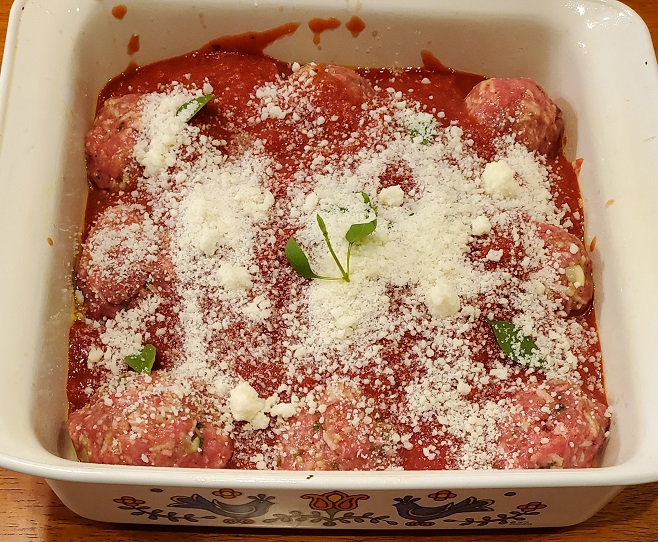 procupine meatballs with sauce and grated cheese