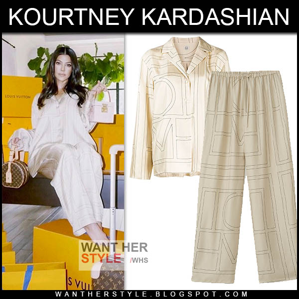 Kourtney Kardashian wearing ivory silk Toteme shirt and pants.