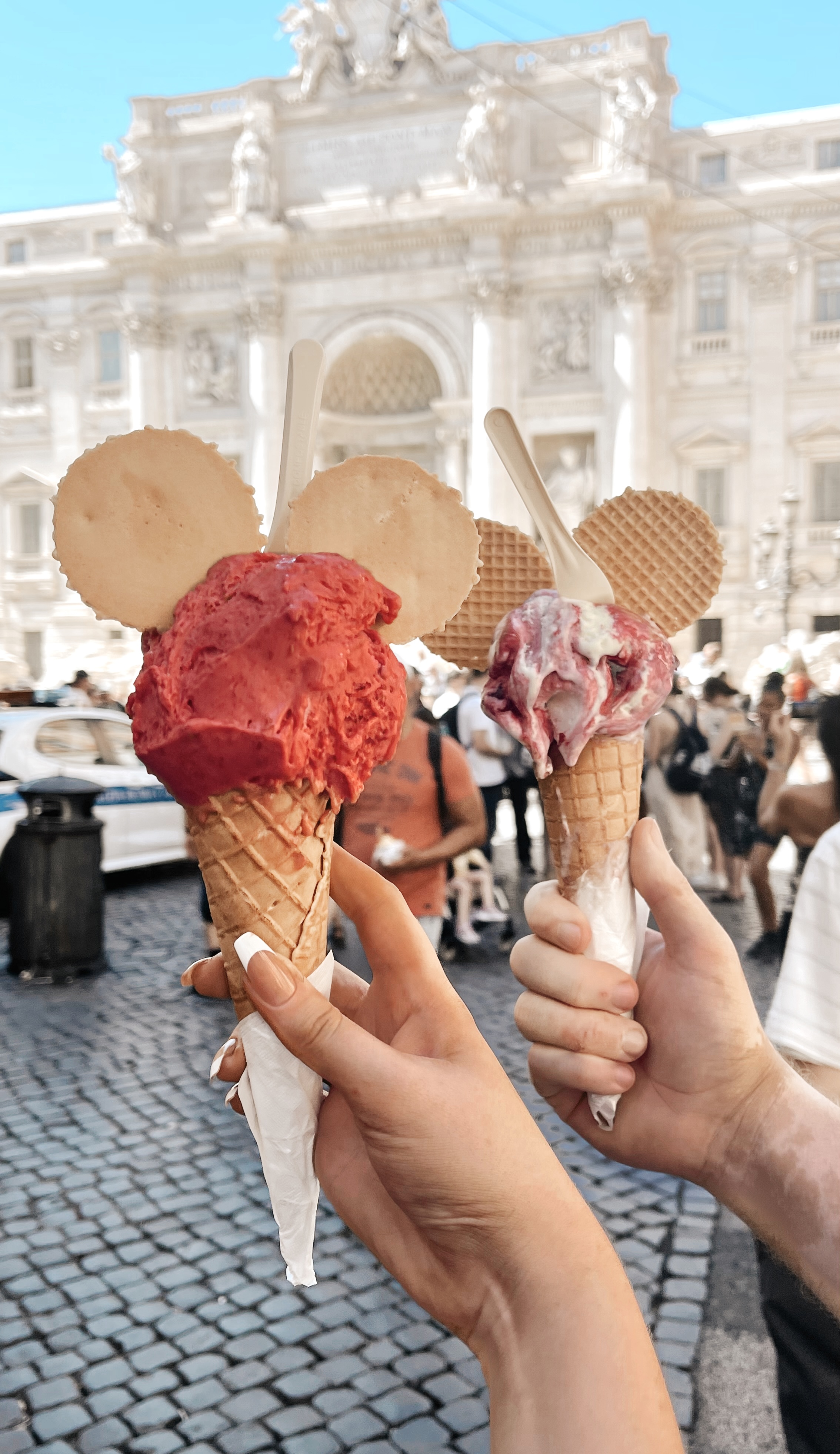 Gelato Ice Cream Cones held in front of the Trevi Fountain.