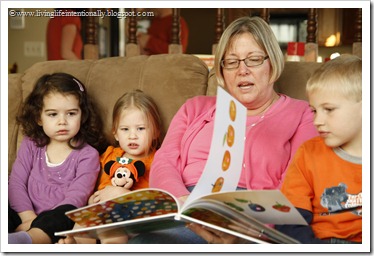 Grandma reading Hungry Caterpillar book at party