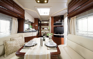 The living area with mahogany-veneer dining table and soft-touch compartments