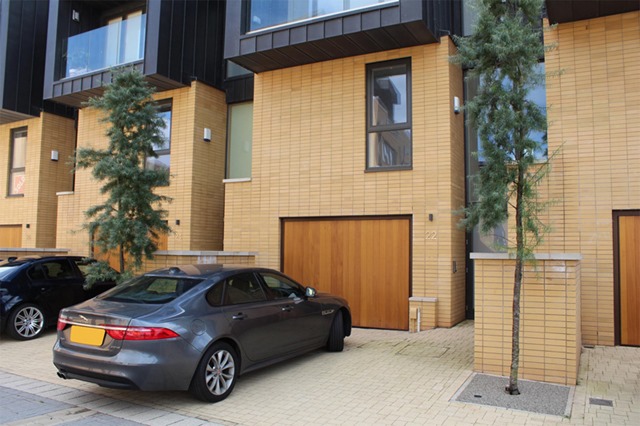 a short driveway with a Garador up and over garage door