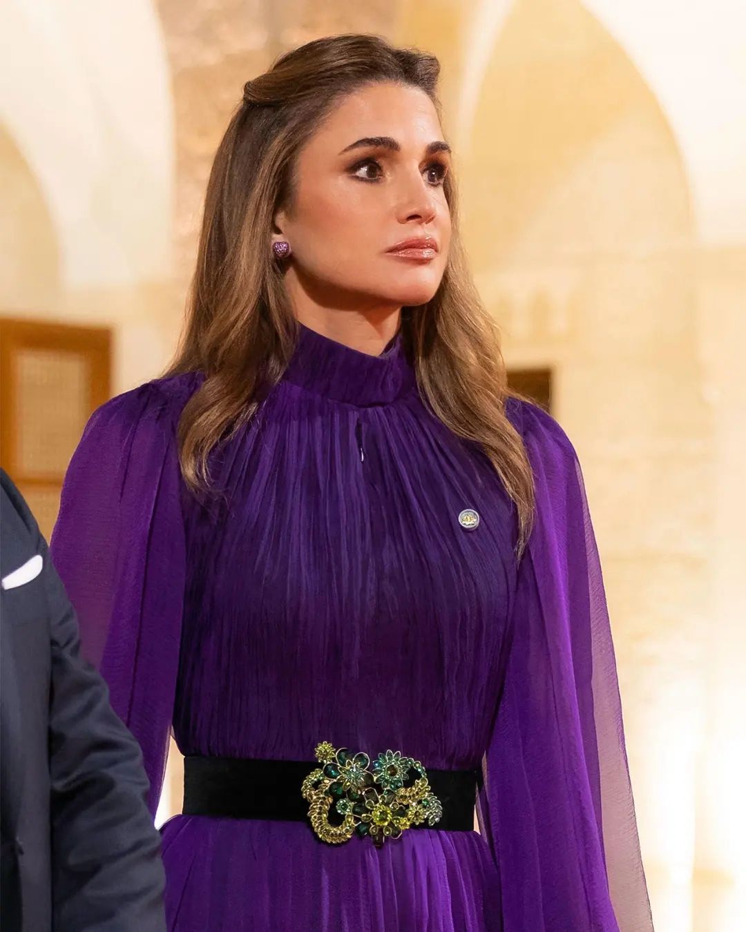 Queen Rania was wearing a purple Andrew GN Balloon-Sleeve Belted Crinkle Chiffon Gown at the Sweden State visit