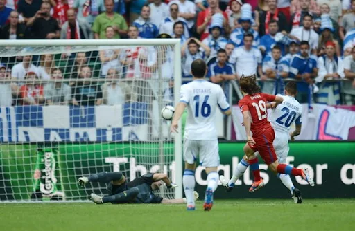 Czech midfielder Petr Jiráček scores in the nets of Greek goalkeeper Kostas Chalkias
