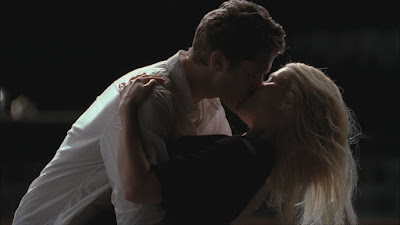 Will and Holly kissing as he leans her down.