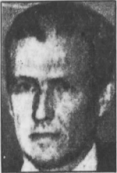 Black and white headshot of a middle-aged white man with brushed-back dark hair