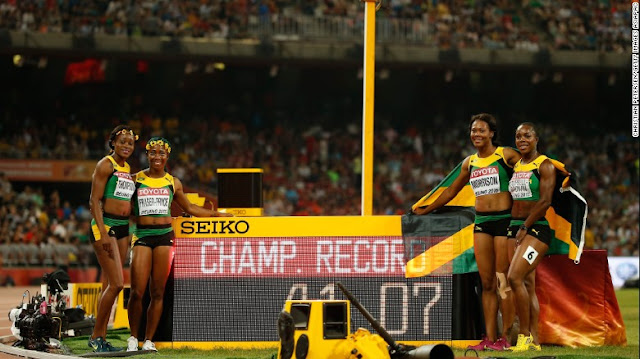 celebrate after winning gold in the women 4x100m final at the World Championships in Athletics in Beijing.