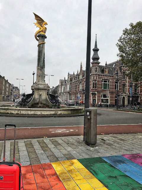 Colourful rainbow road in Den Bosch Netherlands with dragon statue