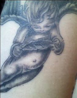 Cute Cherub Angel Tattoo holding a feather