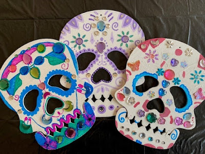 Three painted wooden sugar skulls