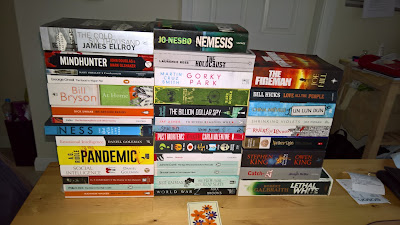 A collection of books on a kitchen table for reading