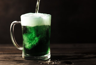 green liquid being poured into a clear mug 