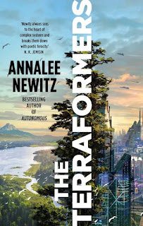 Book "The Terraformers" by Annalee Newitz. The title is written sideways, running up the cover about two thirds of the way from the left hand side. To its left, a landscape of water, mountains and greenery. Behind the title, a tall tree. To the right of the title, modern, latticed buildings, a vertical city.