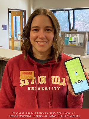 Kelly holding a phone displaying the audio player for Have I Told You This Already?