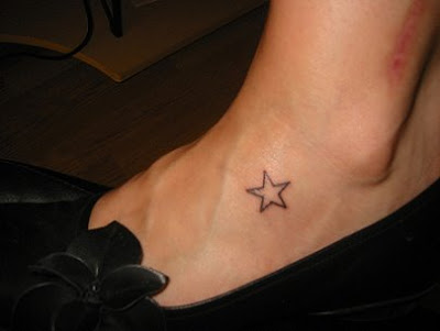 and a tiny crescent moon and stars on her right ankle