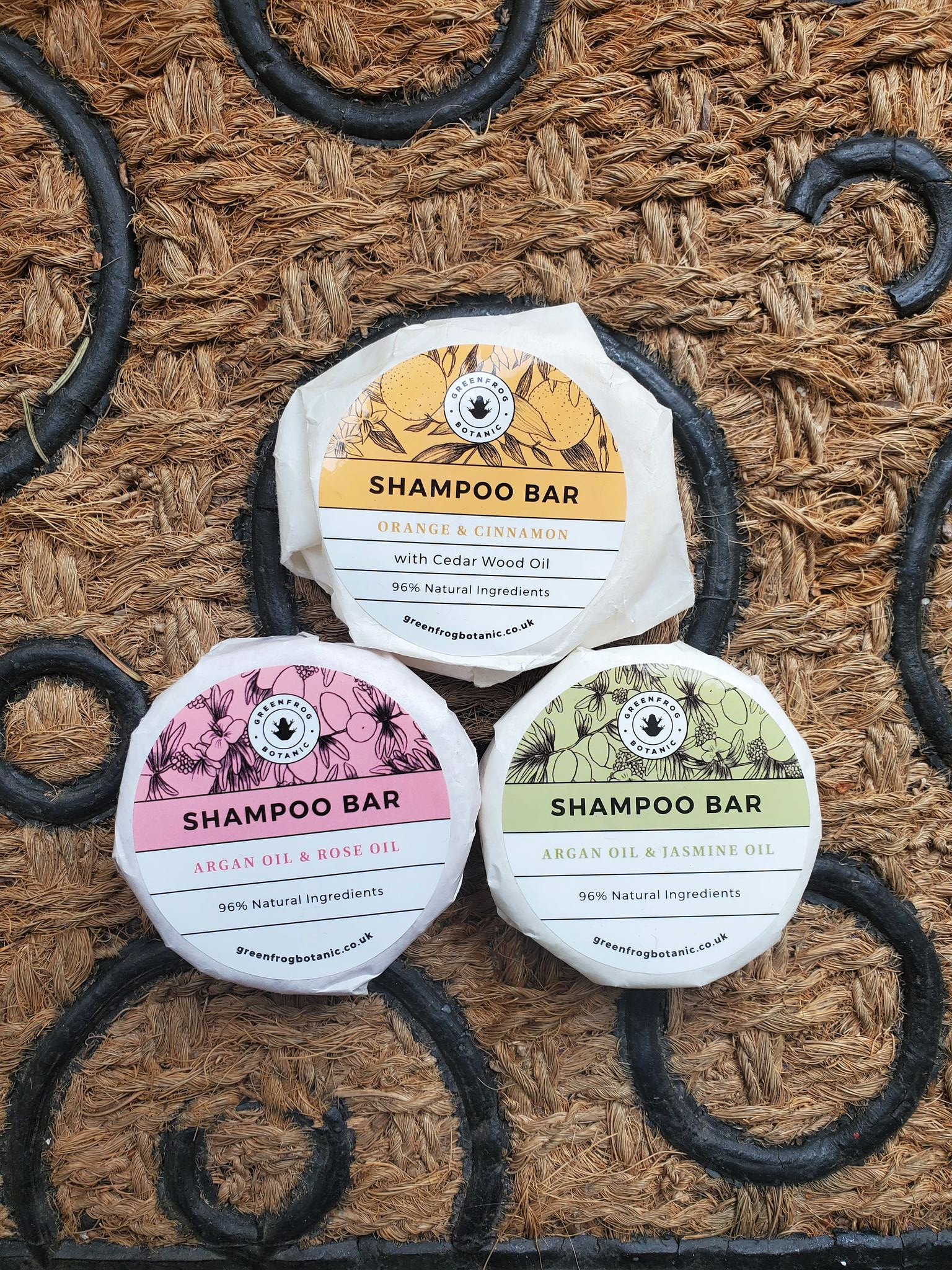 Greenfrog Botanic plastic free shampoo bars in low waste wrappers lined up in a pyramid